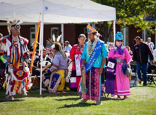 Traditional dancers, with the Miss Harvest Princess standing at center